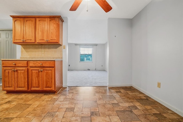 kitchen featuring decorative backsplash and ceiling fan