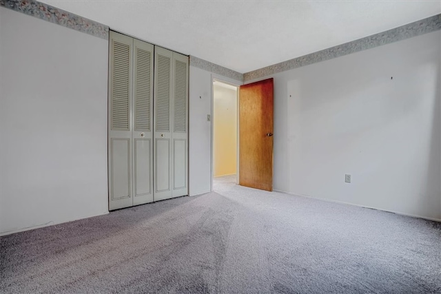 unfurnished bedroom with a closet and carpet