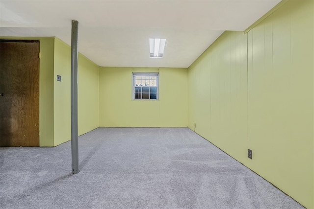 basement featuring light carpet