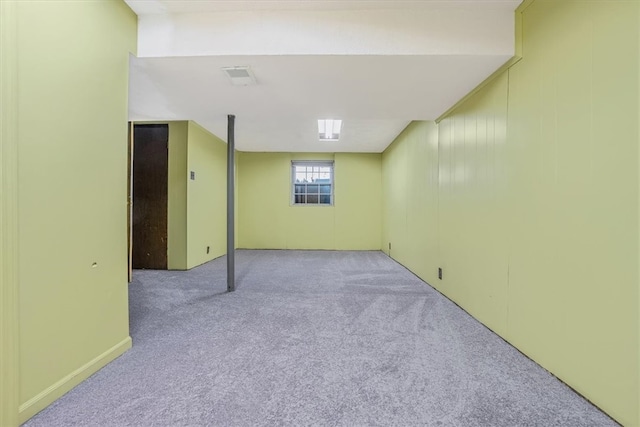 basement featuring light colored carpet