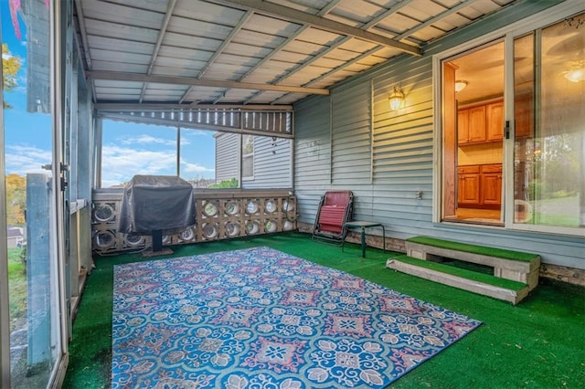 unfurnished sunroom with lofted ceiling