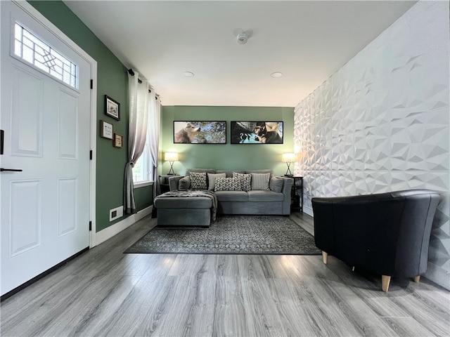 living room featuring tile walls and hardwood / wood-style floors