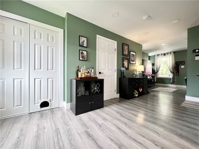 interior space featuring light wood-type flooring and bar