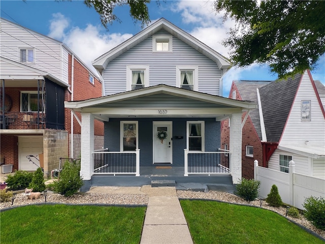 view of front of house with a front lawn and covered porch