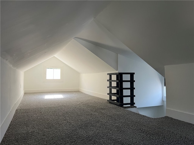 bonus room featuring carpet floors and vaulted ceiling