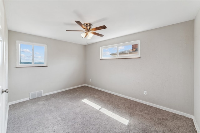 unfurnished room featuring carpet and ceiling fan