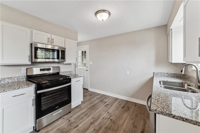 kitchen featuring stainless steel appliances and white cabinetry