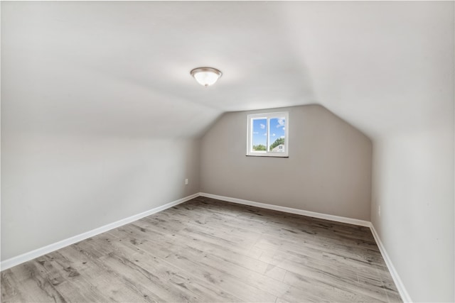 bonus room featuring light hardwood / wood-style flooring and lofted ceiling