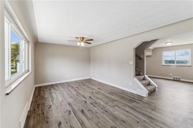 unfurnished room with ceiling fan and wood-type flooring