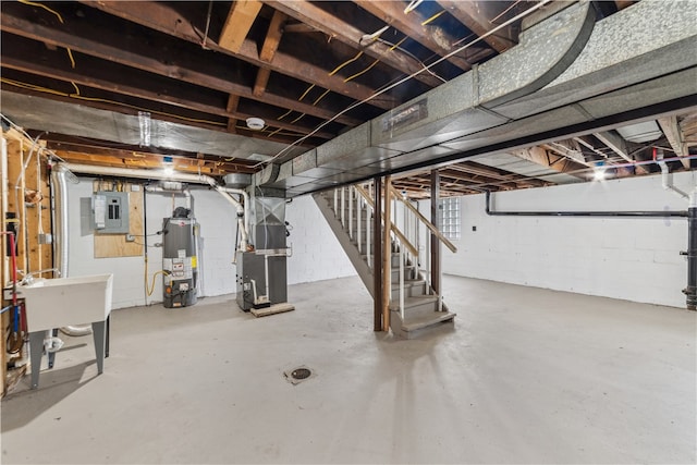 basement with sink, gas water heater, heating unit, and electric panel