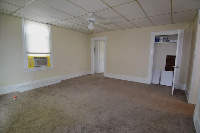 spare room with a drop ceiling, carpet, cooling unit, and a ceiling fan