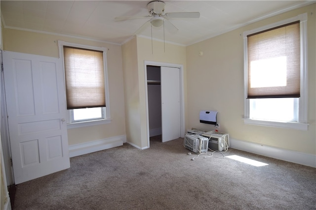 unfurnished bedroom with ceiling fan, carpet flooring, and multiple windows