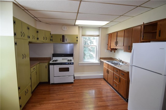 kitchen with a drop ceiling, white appliances, dark wood-type flooring, a sink, and green cabinets