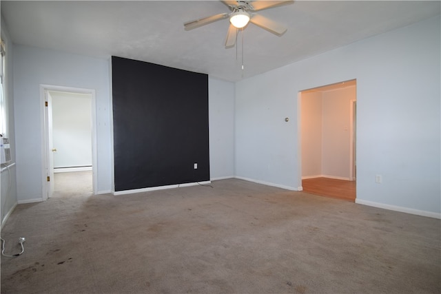 spare room featuring ceiling fan, a baseboard radiator, and carpet flooring