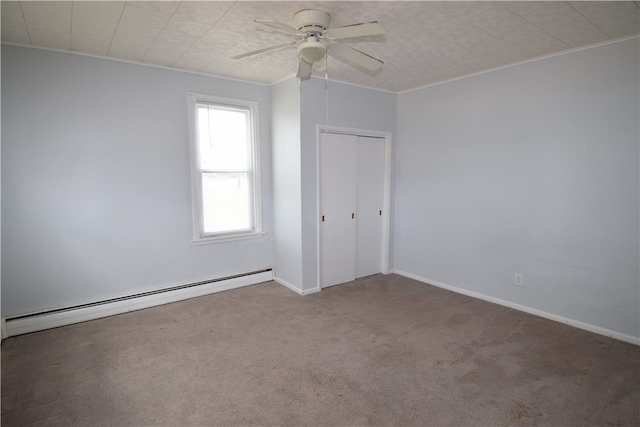 carpeted empty room featuring ceiling fan, ornamental molding, and baseboard heating