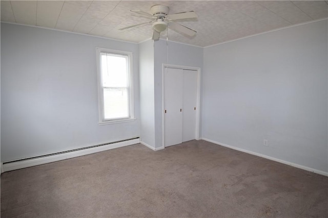 unfurnished bedroom featuring a closet, a baseboard heating unit, carpet flooring, ceiling fan, and baseboards