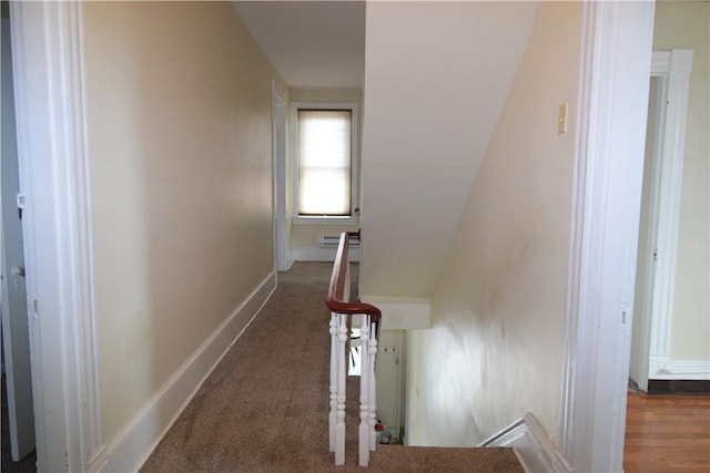 hall featuring carpet floors and baseboards