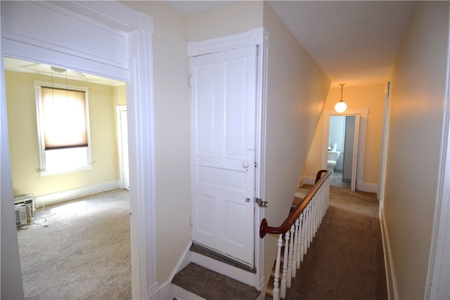 corridor featuring carpet and a wall mounted air conditioner