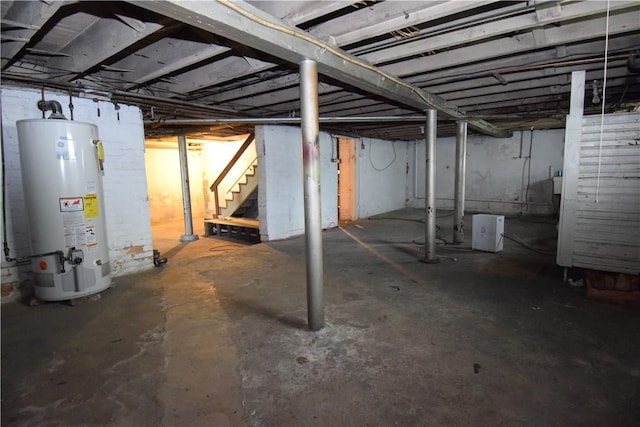 unfinished basement featuring water heater