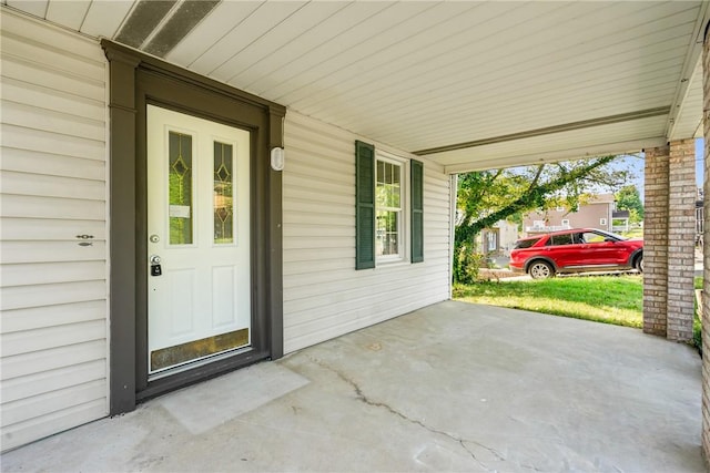 view of exterior entry featuring a porch