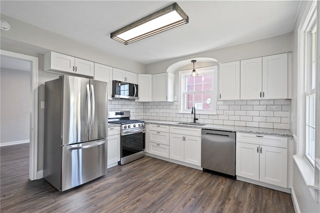 kitchen featuring sink, stainless steel appliances, dark wood-type flooring, and white cabinetry