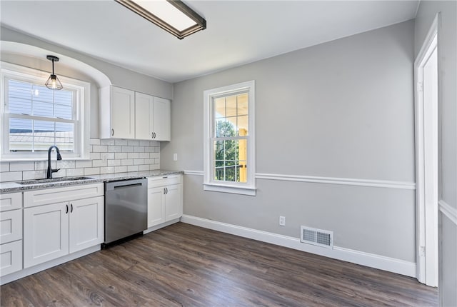 kitchen featuring sink, backsplash, stainless steel dishwasher, and dark hardwood / wood-style floors