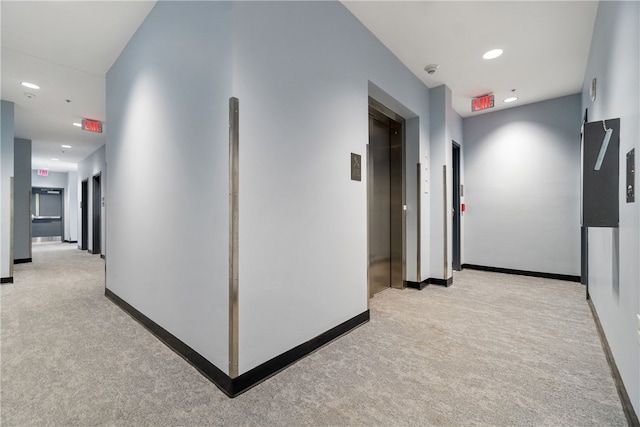 hall featuring recessed lighting, elevator, light colored carpet, and baseboards