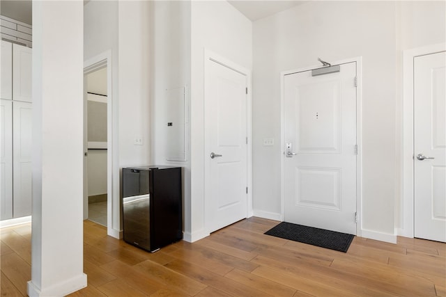 foyer entrance with light wood-type flooring and baseboards