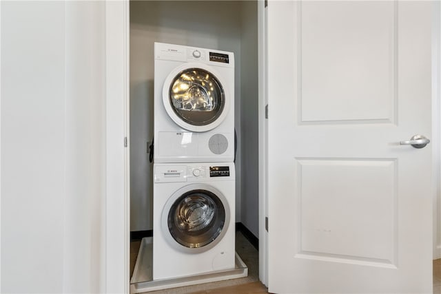 washroom featuring laundry area and stacked washer / drying machine