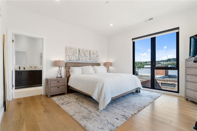 bedroom with connected bathroom, recessed lighting, visible vents, access to outside, and light wood-type flooring