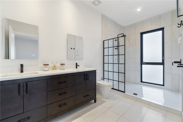 full bathroom with double vanity, a sink, and a walk in shower