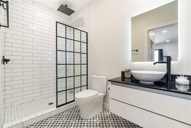 bathroom with toilet, a stall shower, tile patterned flooring, and vanity