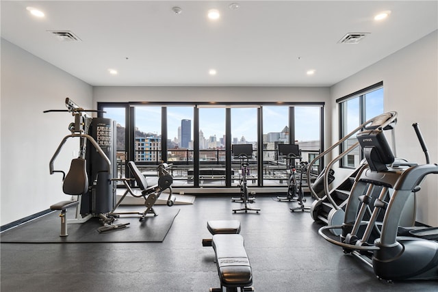 exercise room with recessed lighting, visible vents, and baseboards