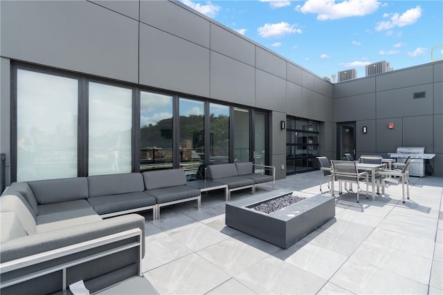 view of patio / terrace featuring outdoor dining area, an outdoor living space with a fire pit, and grilling area