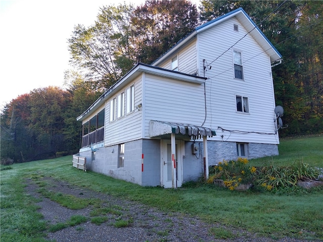 view of property exterior featuring a lawn