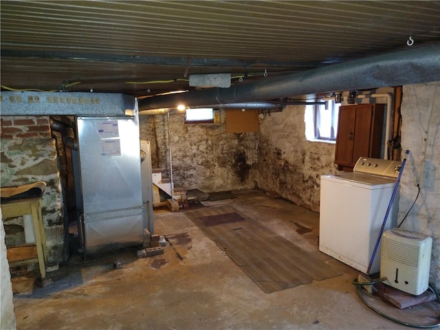 basement with washer / dryer and heating unit