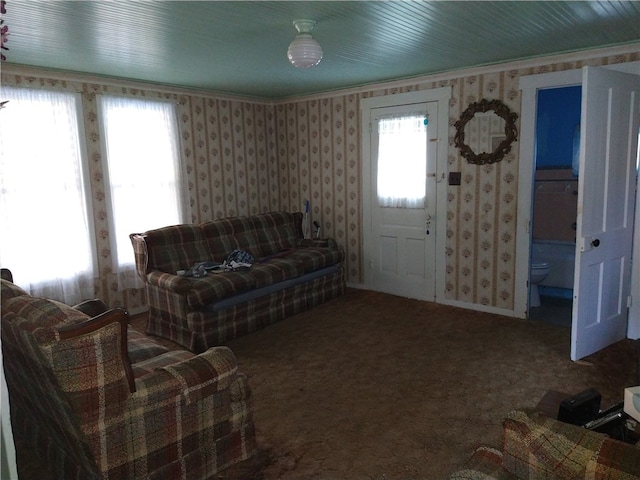 living room featuring wallpapered walls, carpet, and ornamental molding