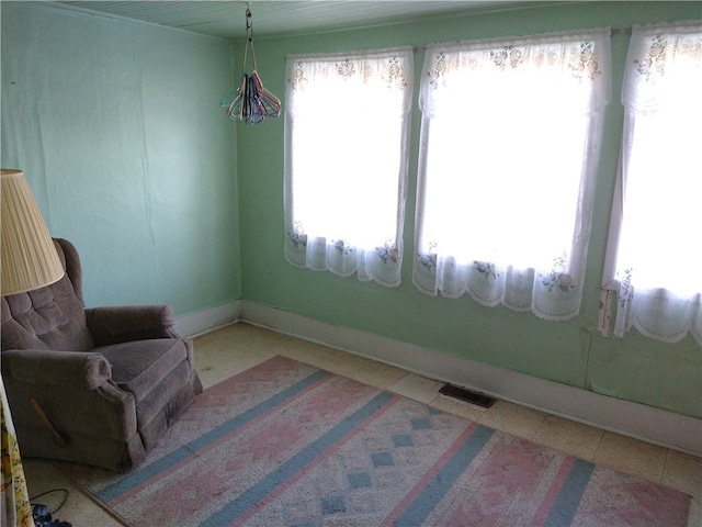 sitting room with tile patterned flooring, visible vents, and baseboards