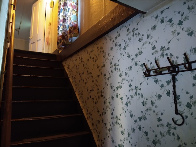 staircase with wallpapered walls