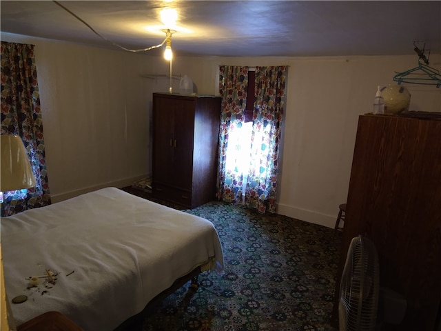 bedroom featuring carpet and baseboards