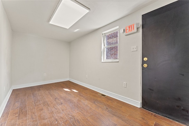 empty room with hardwood / wood-style floors