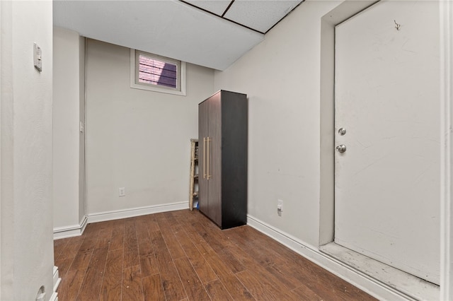 basement featuring dark hardwood / wood-style flooring