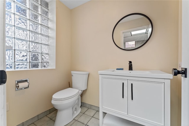 bathroom with tile patterned flooring, vanity, and toilet