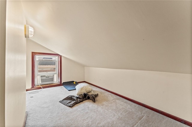 interior space featuring cooling unit, lofted ceiling, and carpet flooring