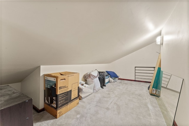 bonus room featuring vaulted ceiling and carpet floors