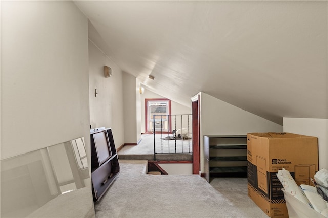 interior space featuring light carpet and lofted ceiling