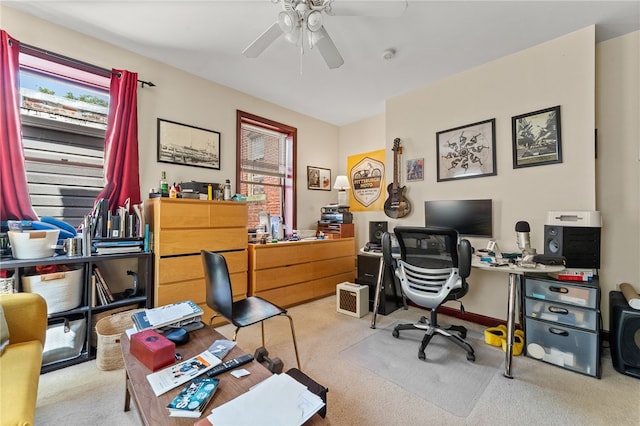 carpeted home office with ceiling fan