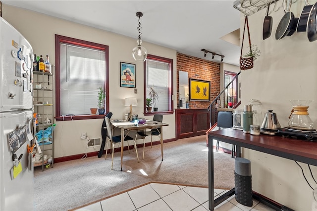 office area with light tile patterned floors and rail lighting