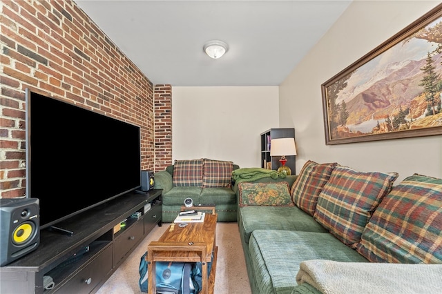 carpeted living room featuring brick wall