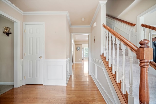 interior space featuring ornamental molding and light wood-type flooring